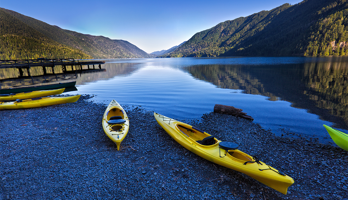 Yellow kayaks on a lake shore