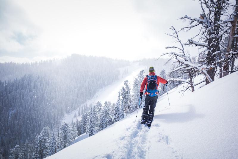 Skier ascending a snowy slope